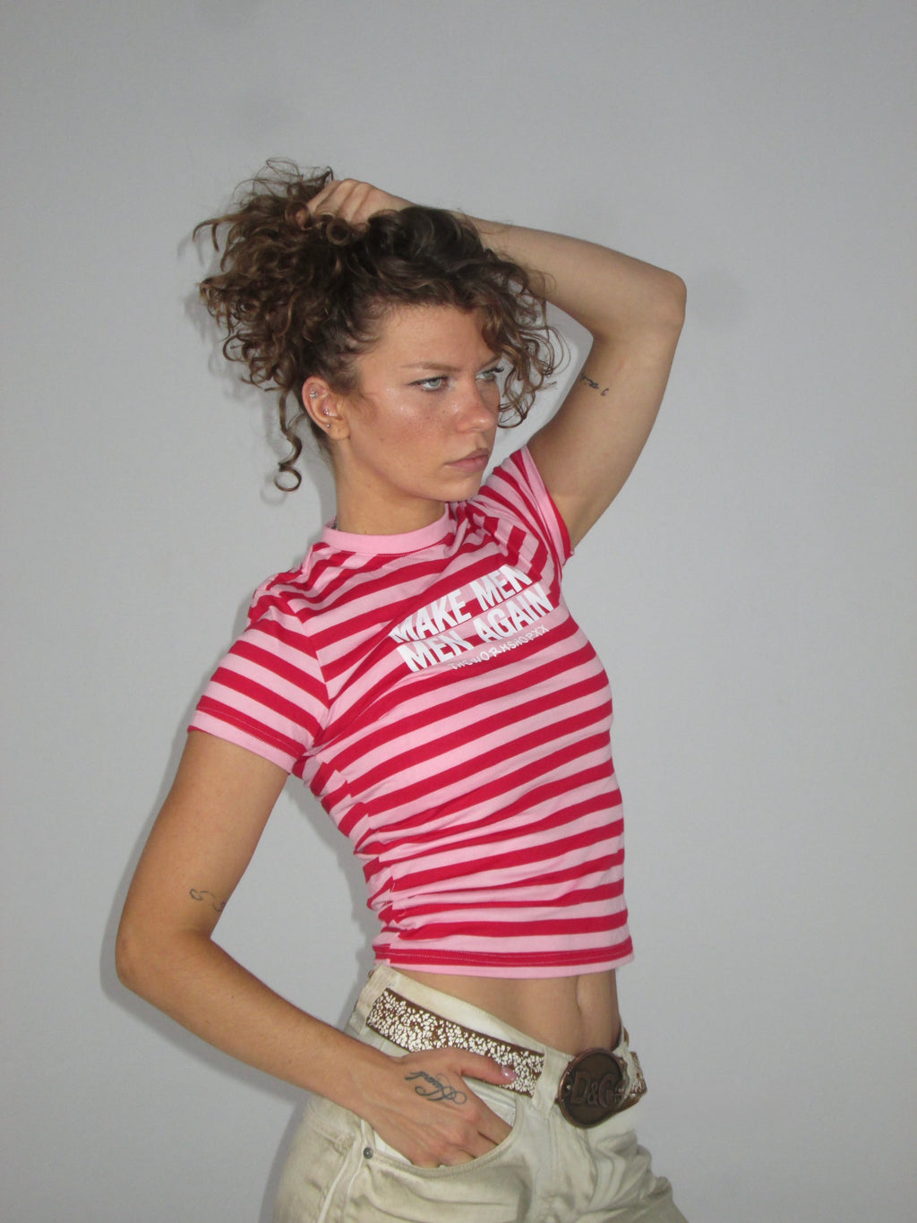 Make men men again in red-pink striped baby tee